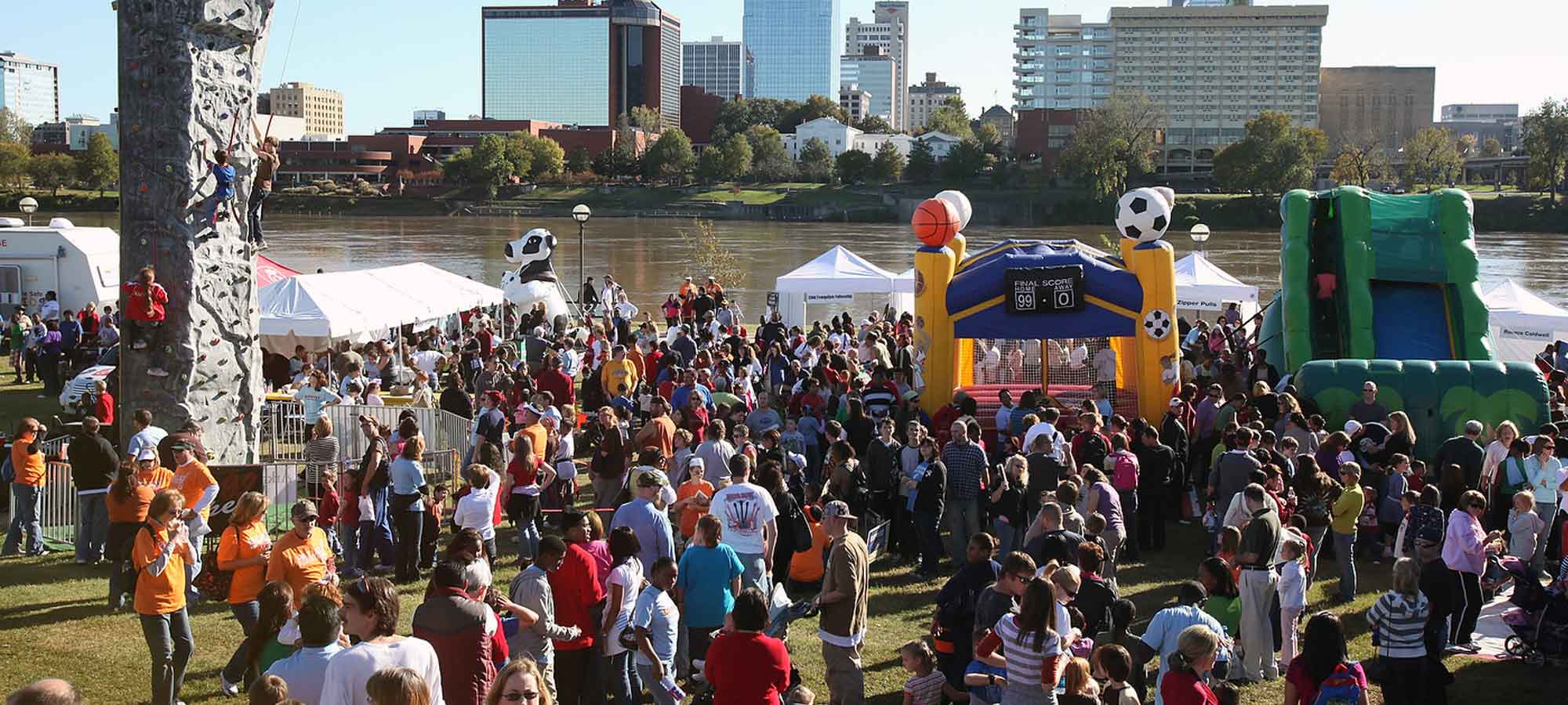 citywide event by river, with downtown Little Rock in background