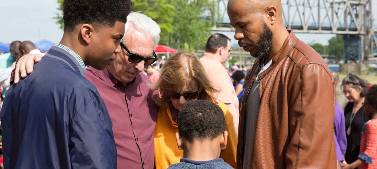 mixed ethnicity group praying