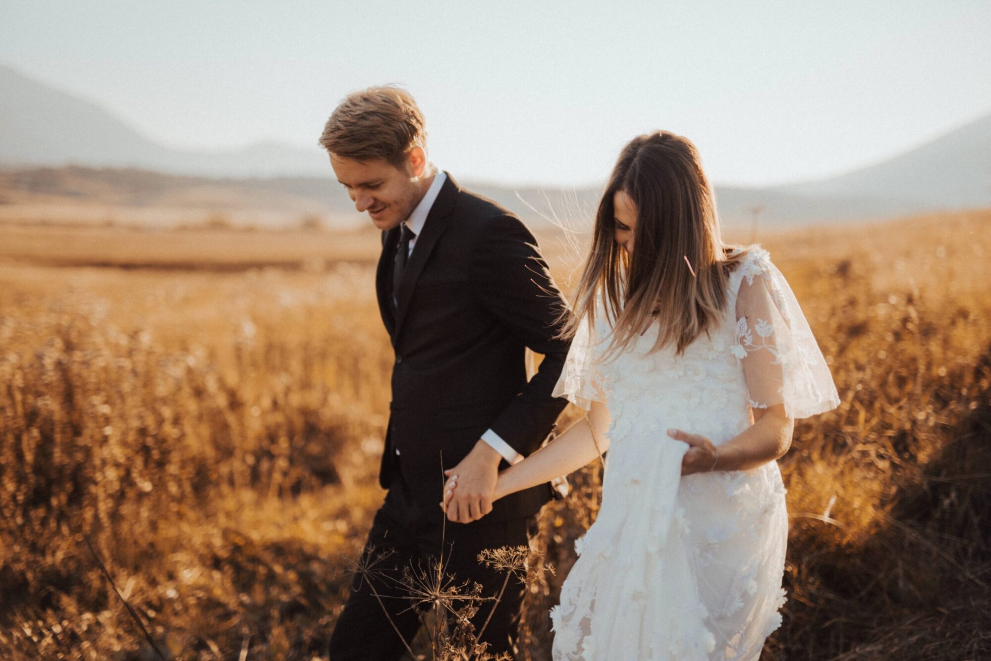 Bride and groom in field