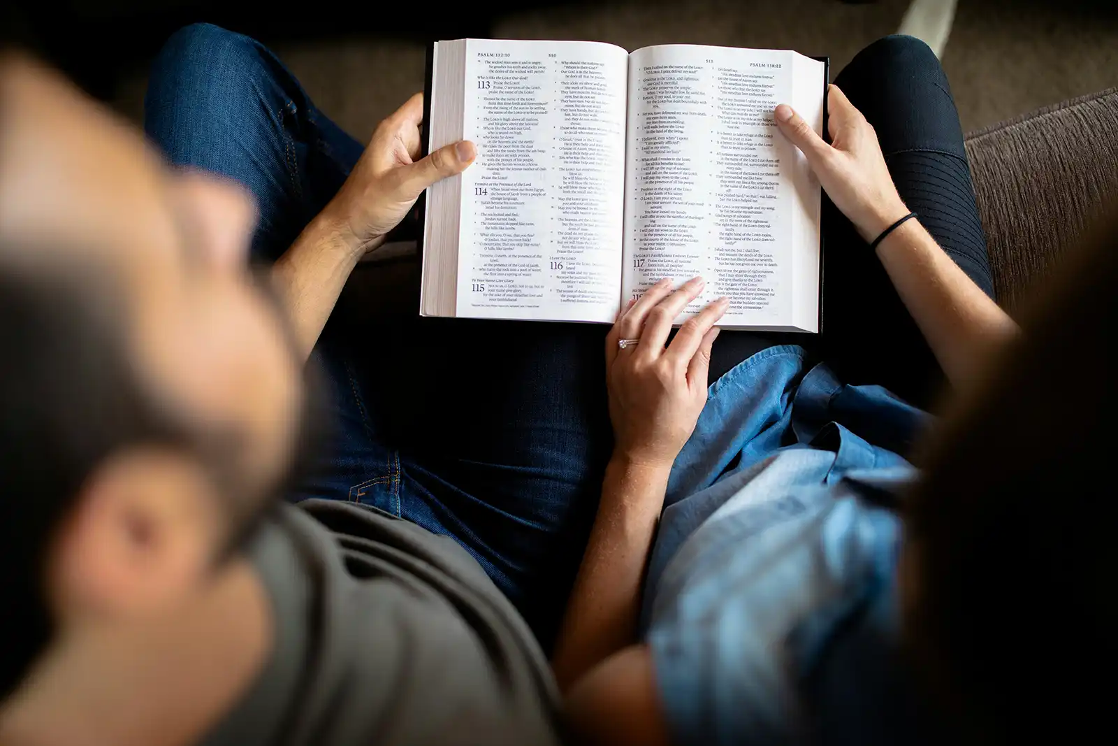 man and woman reading Bible together