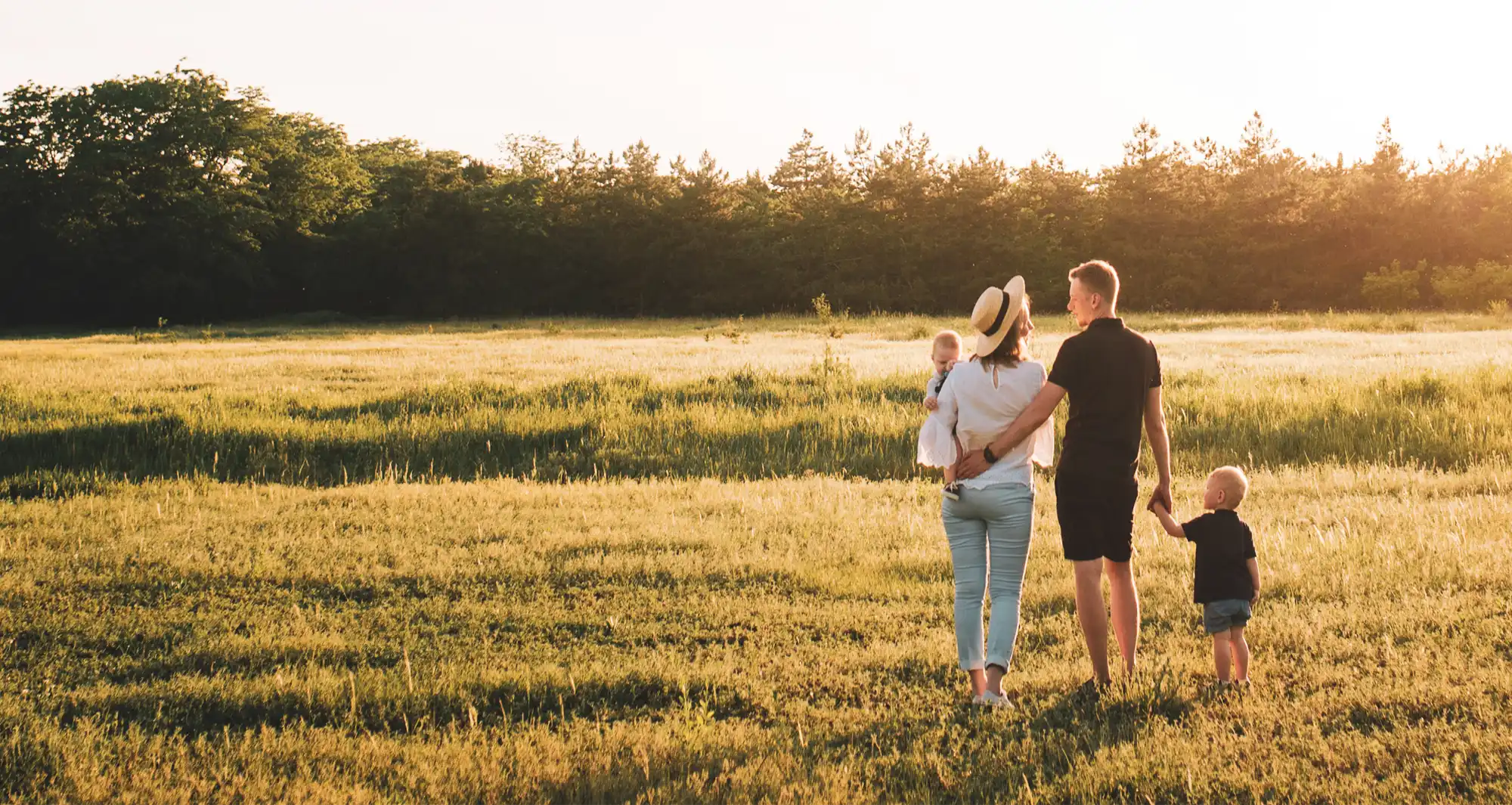 parents and children standing in field