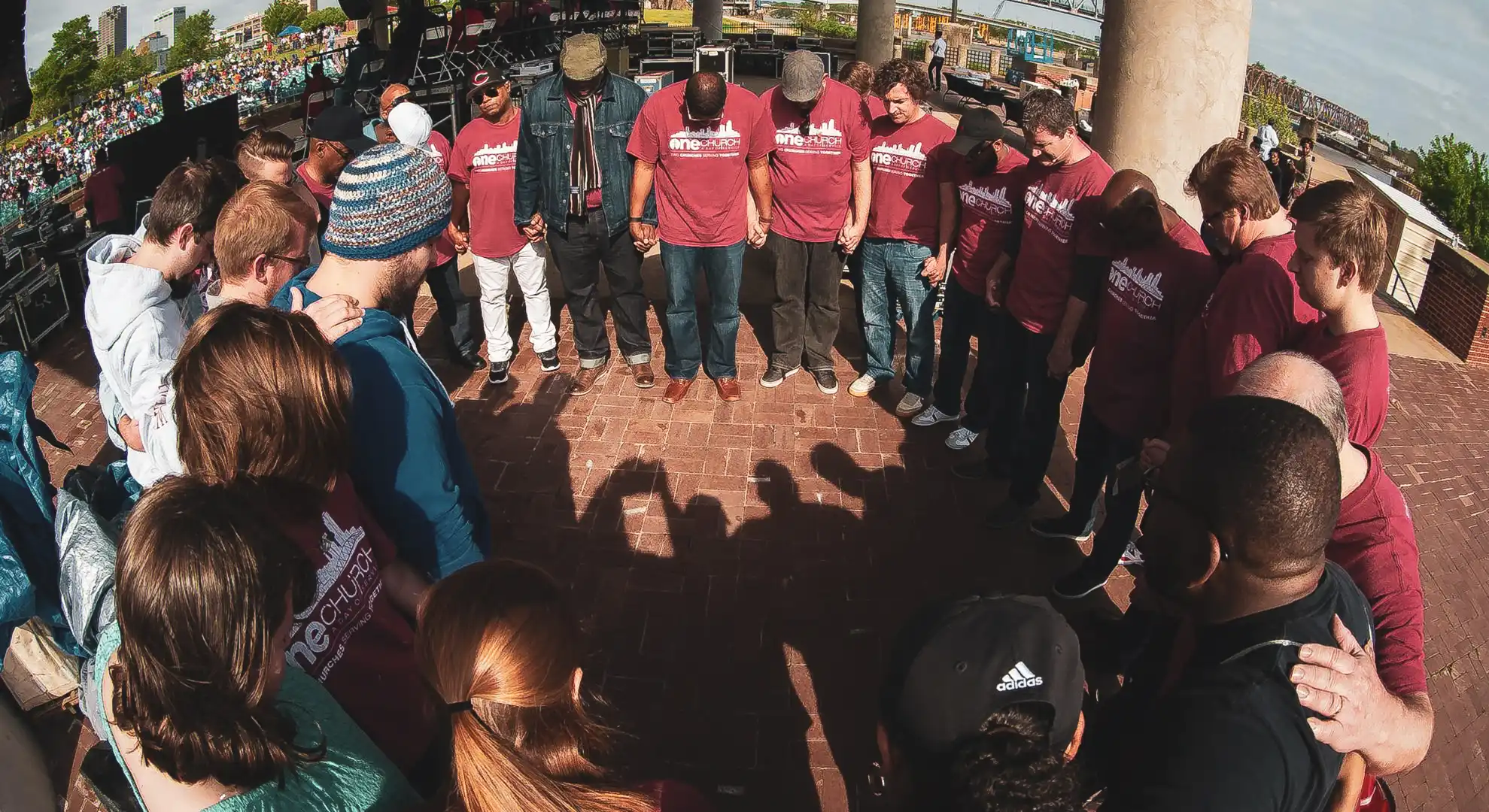 circle of people praying at Little Rock Riverfront