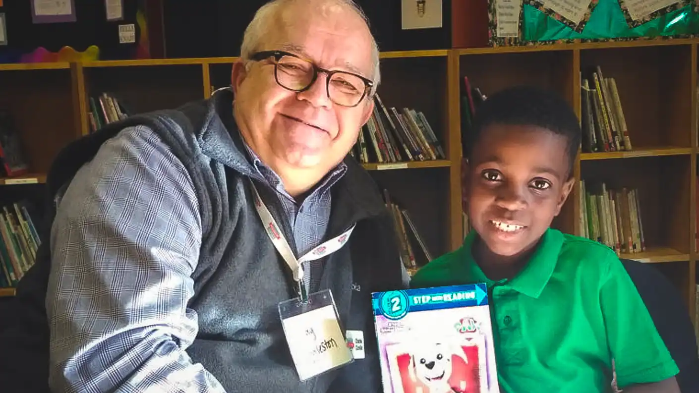 man and boy holding book