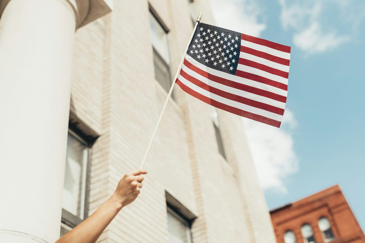 person waiving american flag