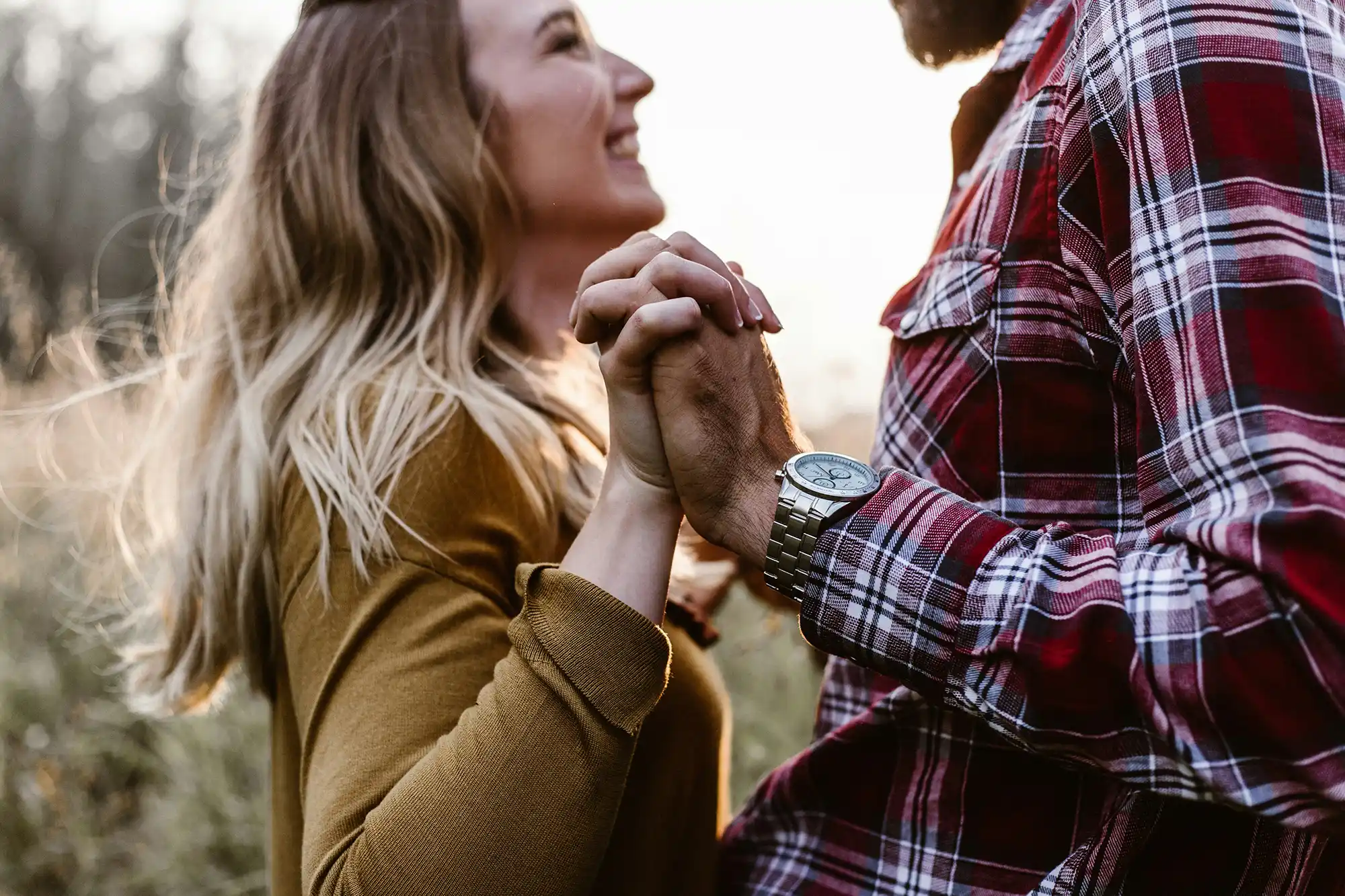 couple facing each other, holding hands