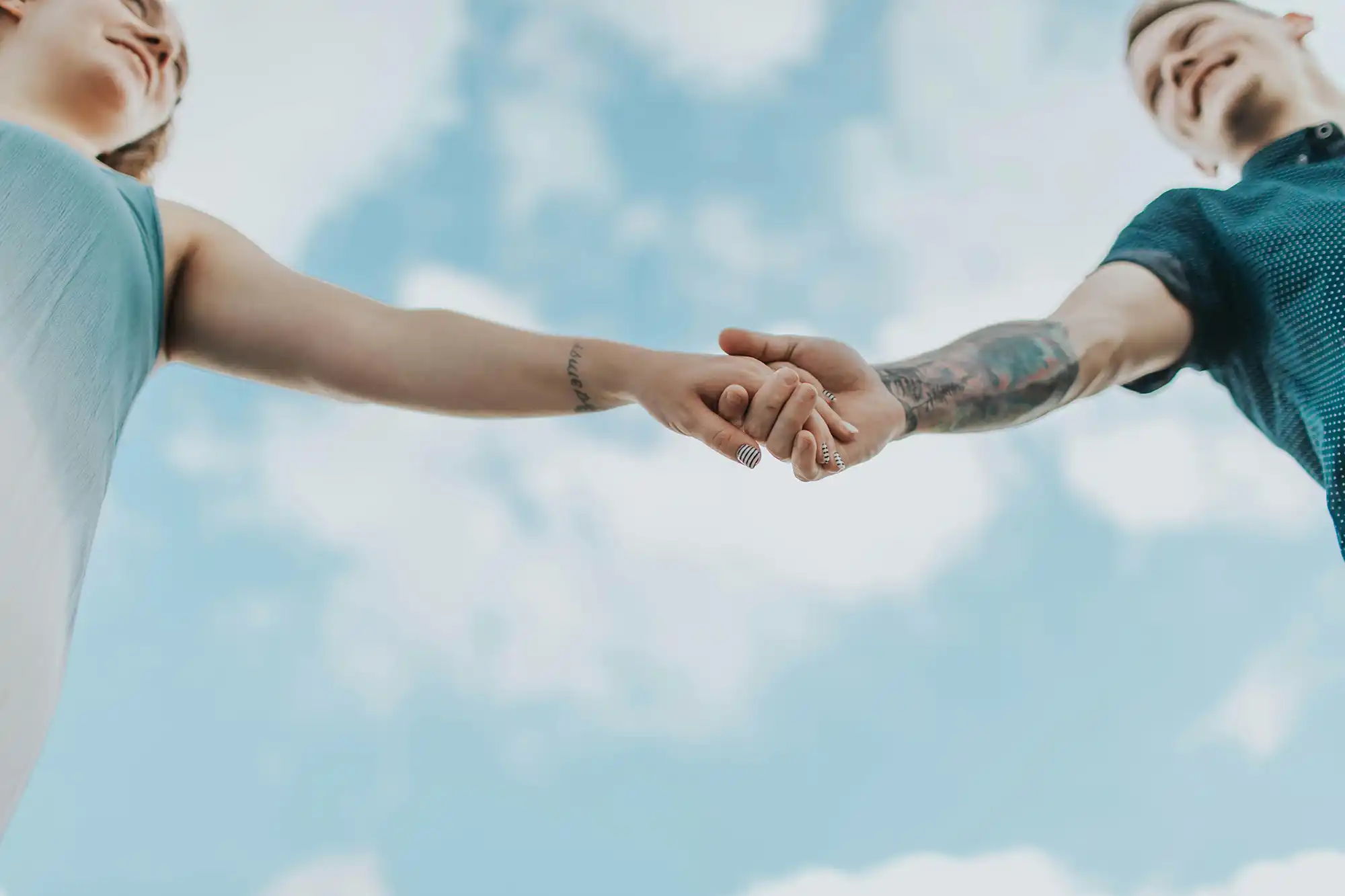 couple holding hands with outstretched arms