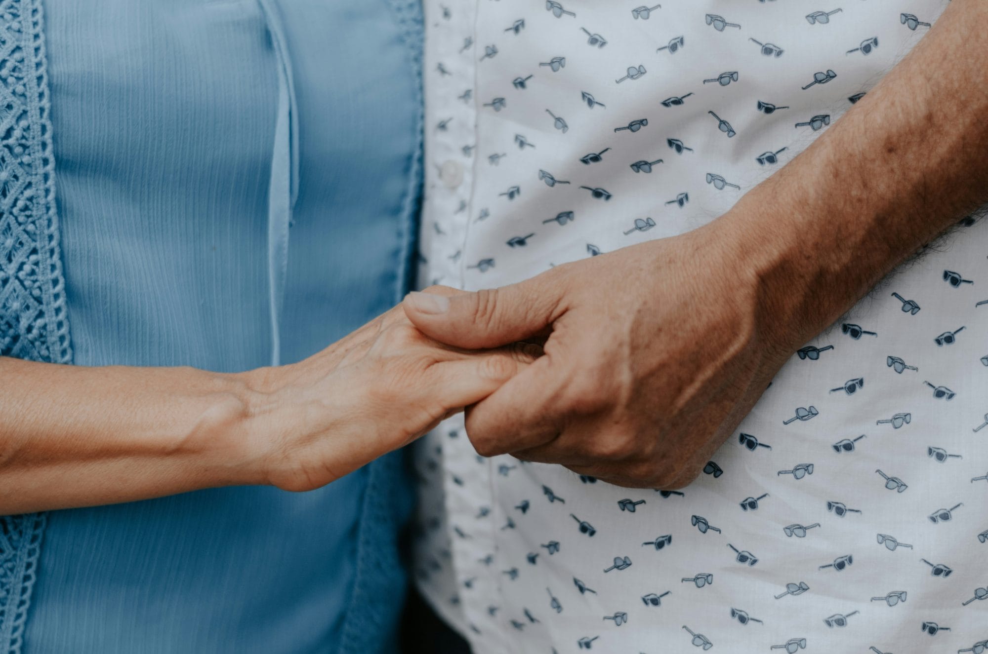 old couple holding hands