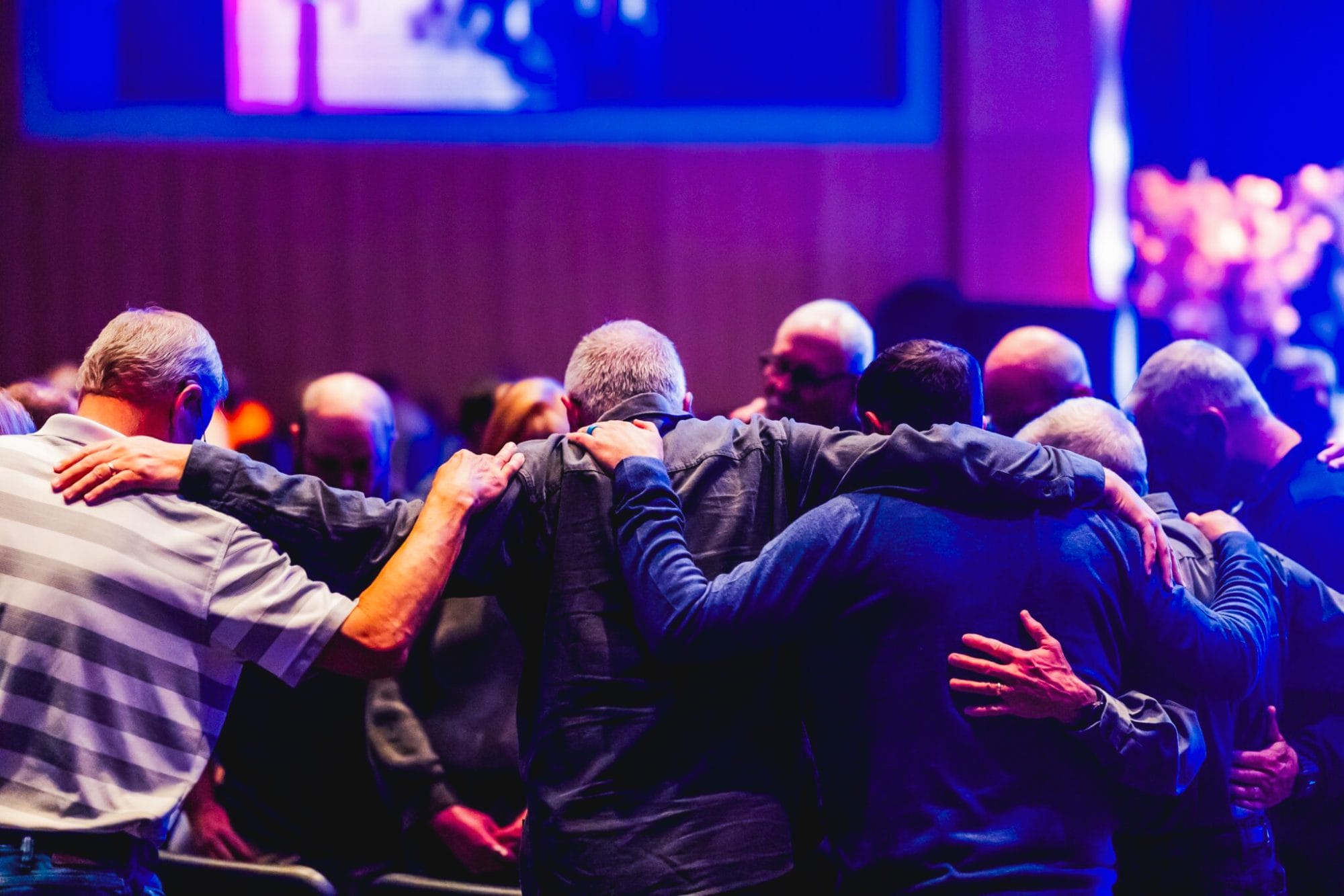 Men praying at One Voice event