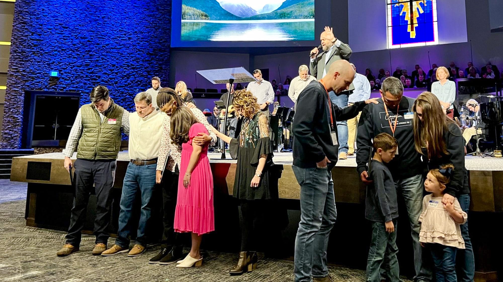 Leaders being prayed over during Kingdom Cooperation's commissioning