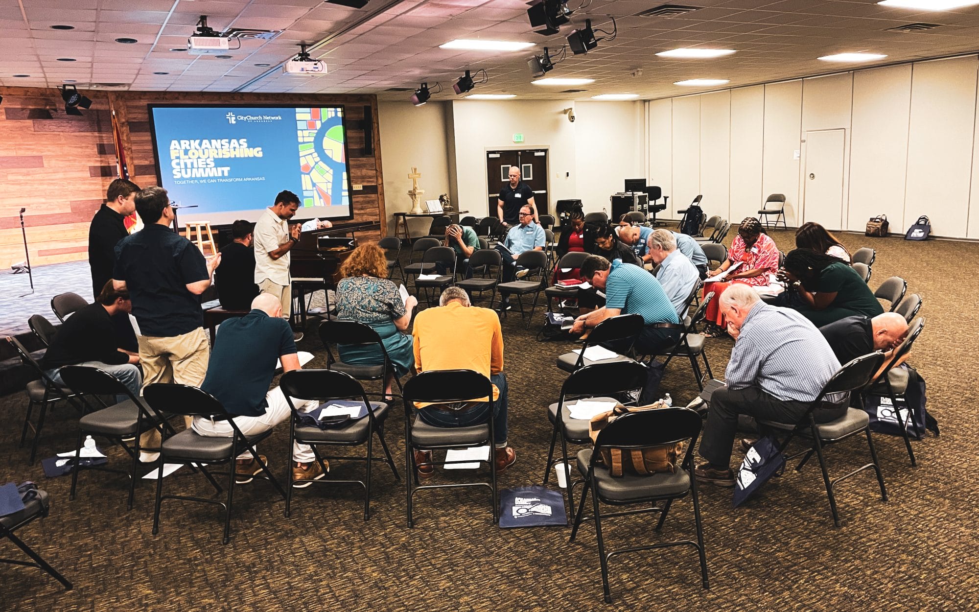 Prayer during the Arkansas Flourishing Cities Summit