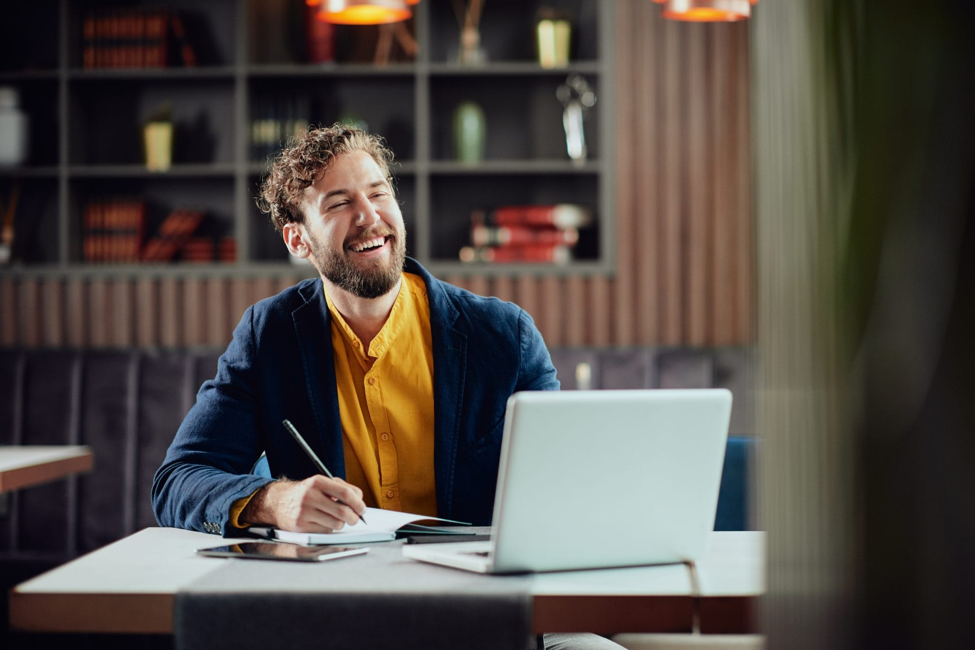 man at desk laughing