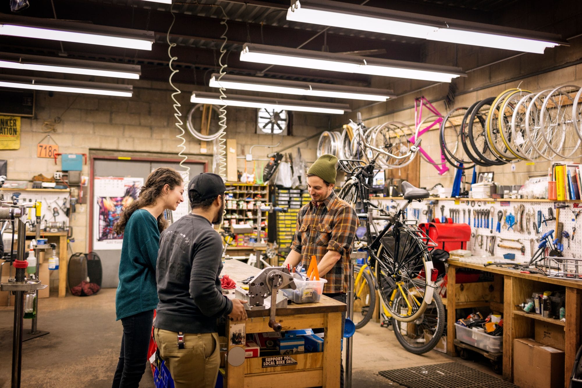 man talking to customers in bicycle shop