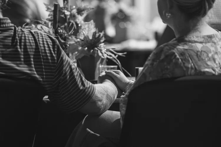 Couple holding hands at table