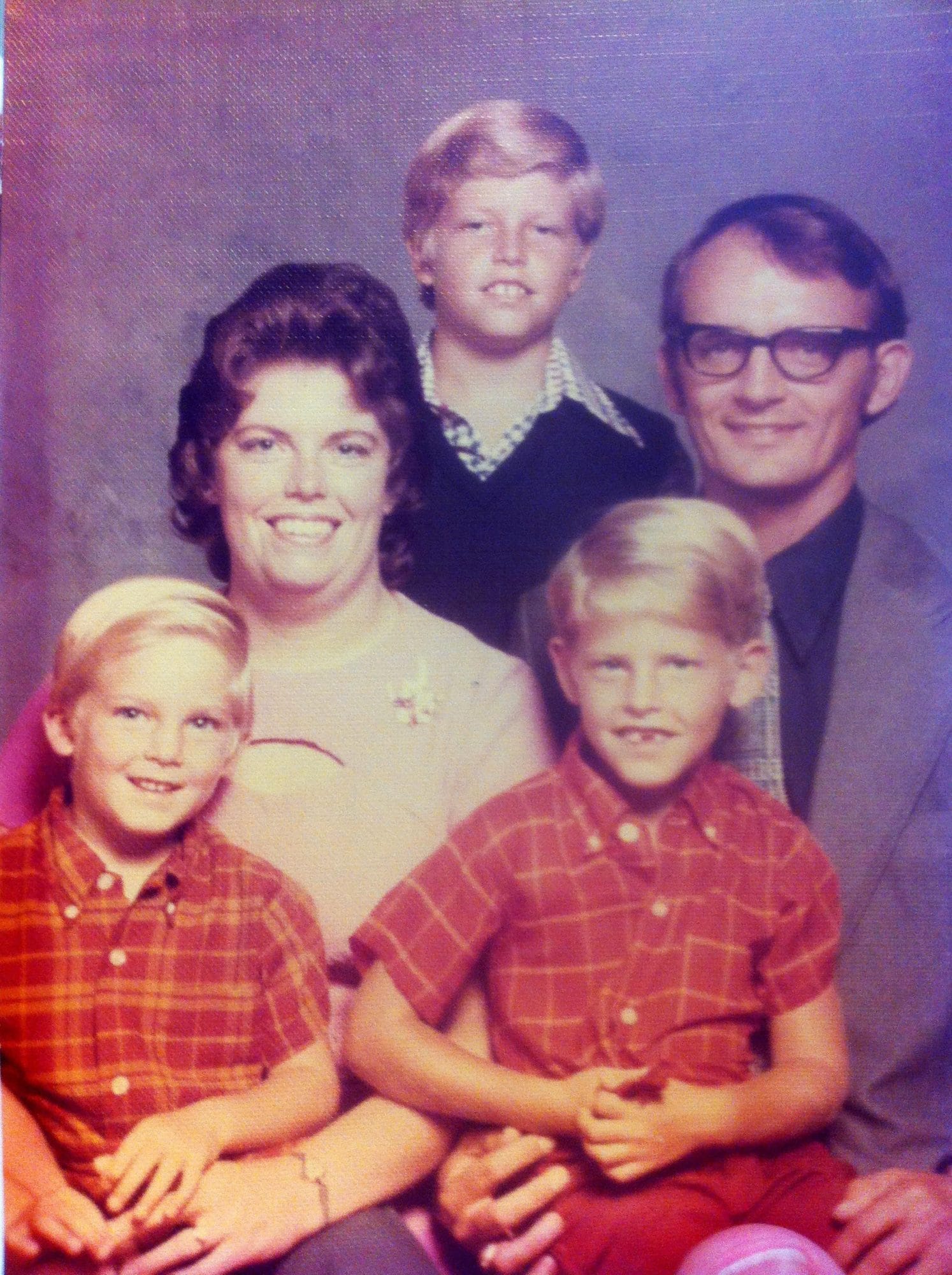Old family portrait of a mother, father, and three kids