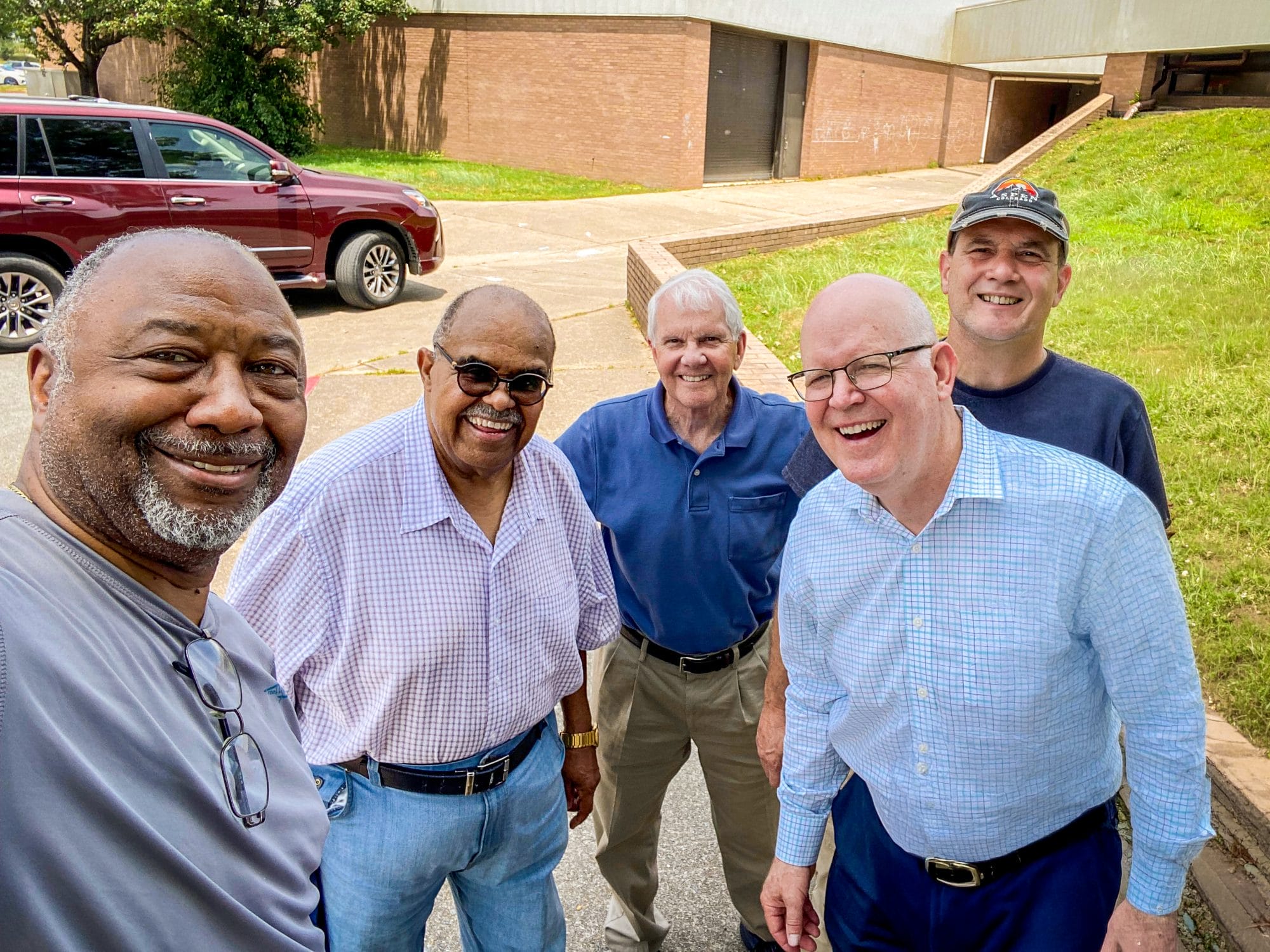 Older men smiling together for a group photo