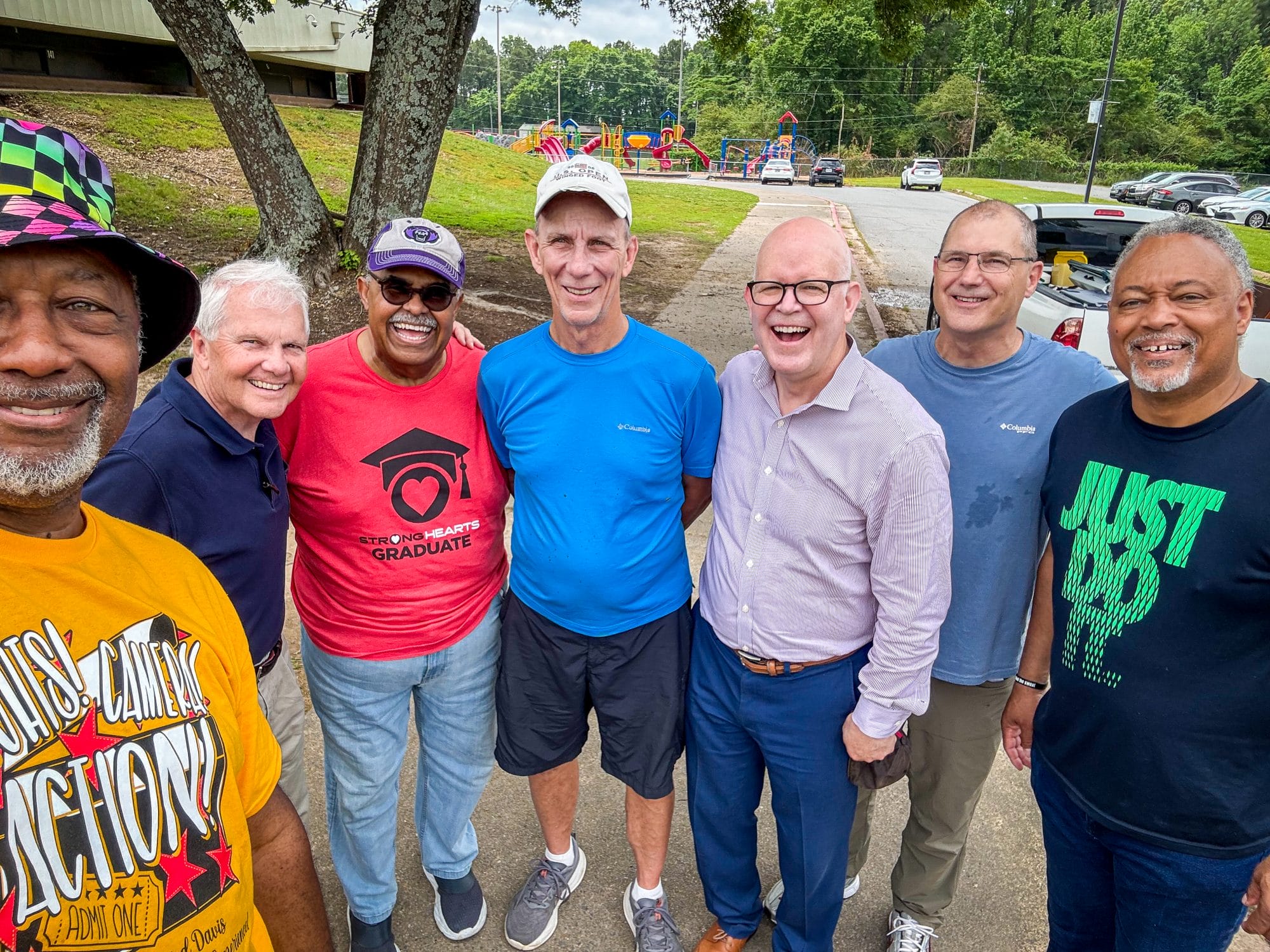 group of black and white men in a group smiling for a photograph
