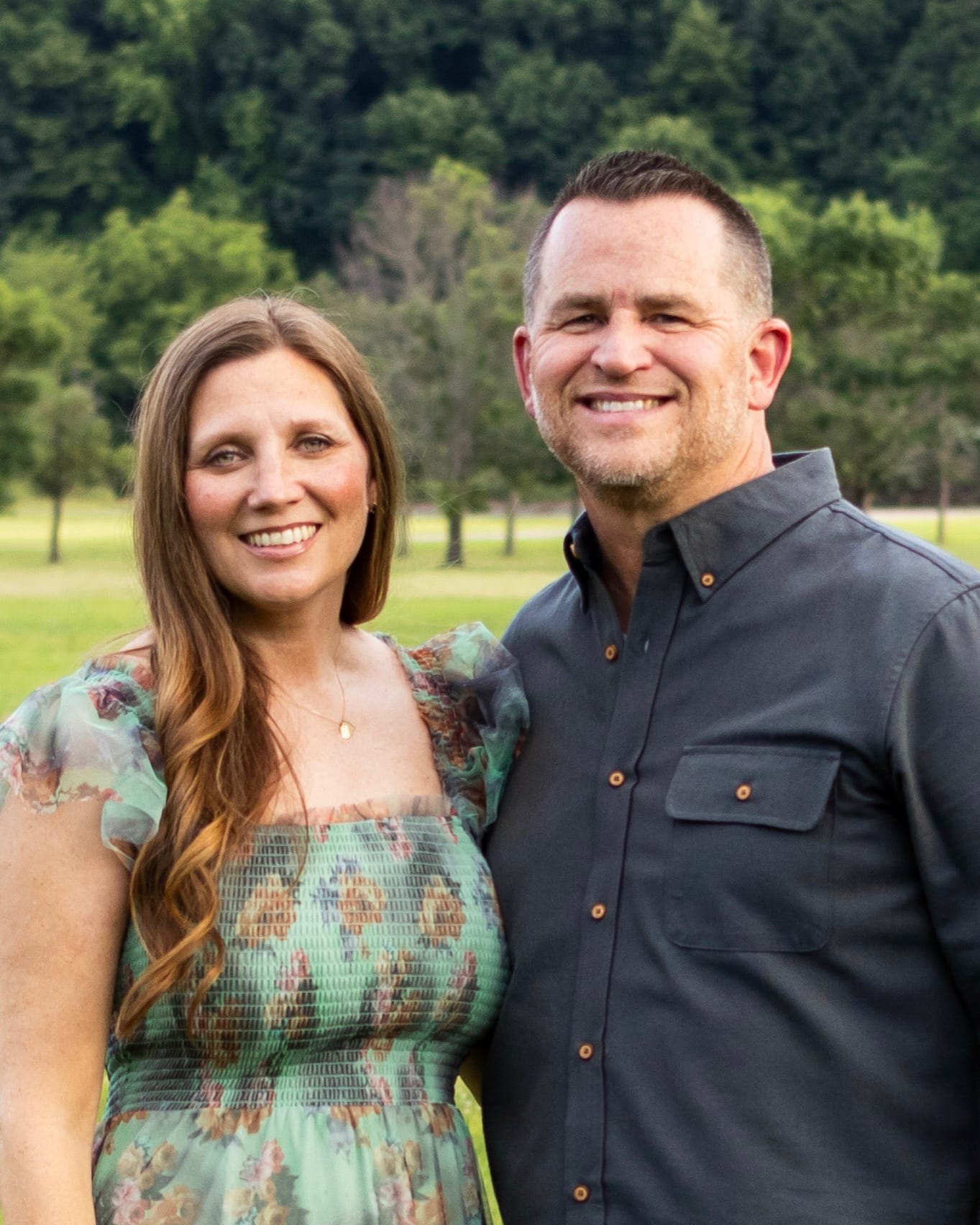 couple smiling with nature background